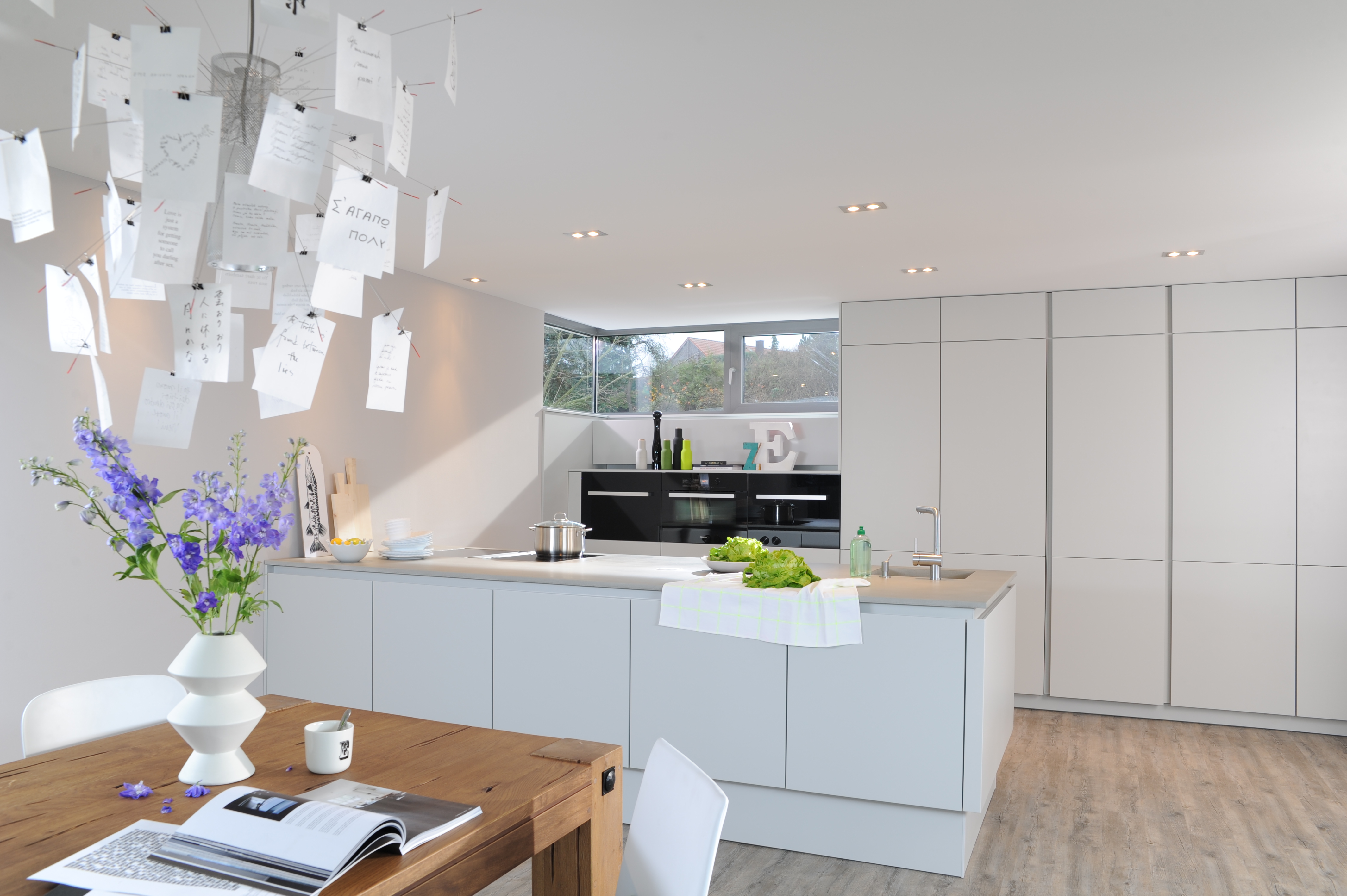 Moderne inselküche mit betonarbeitsplatte und weiÃen fronten
